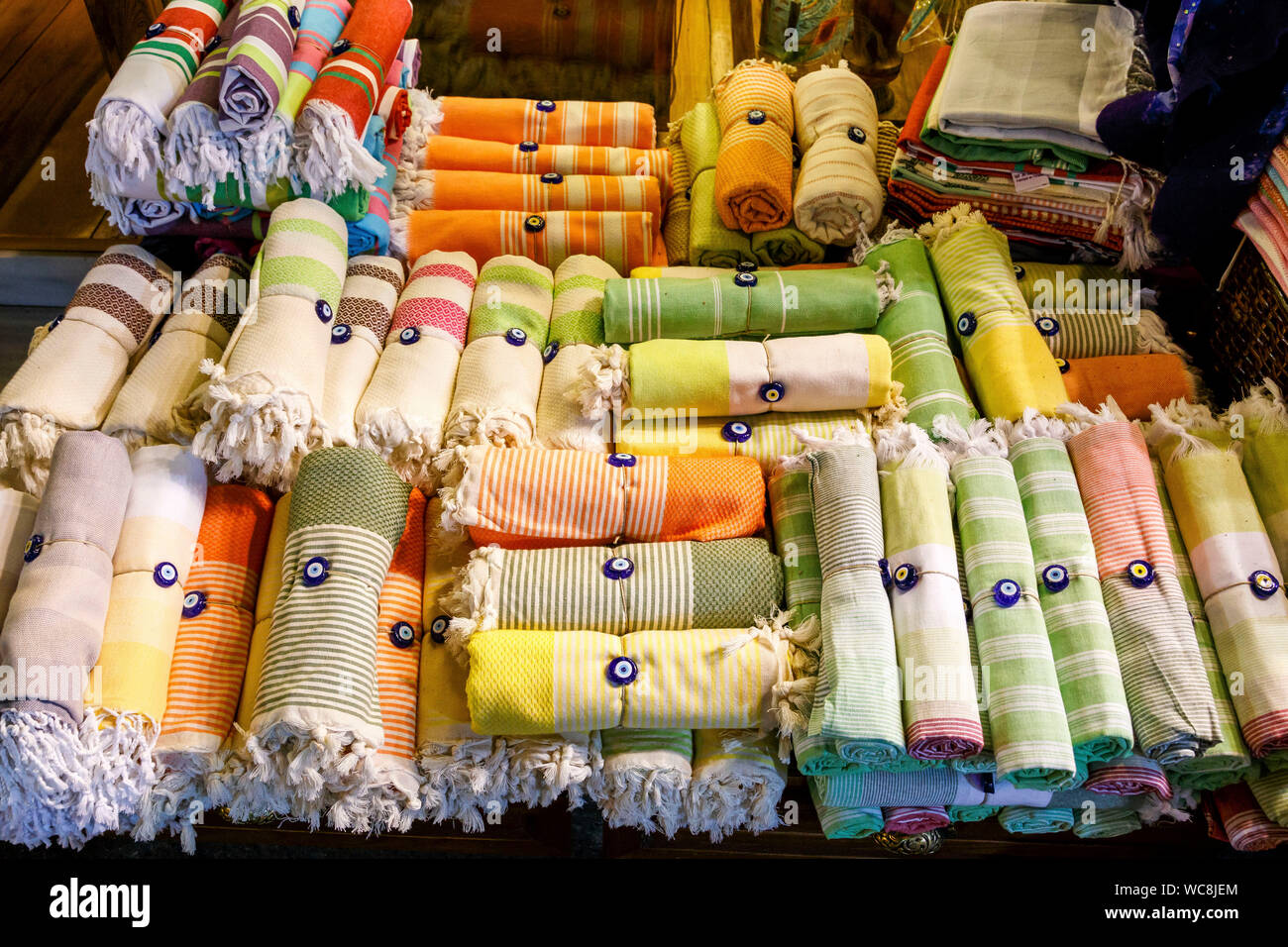 High Angle View Of Rolled Up Towels Tied With Evil Eye Beads At Market For  Sale Stock Photo - Alamy