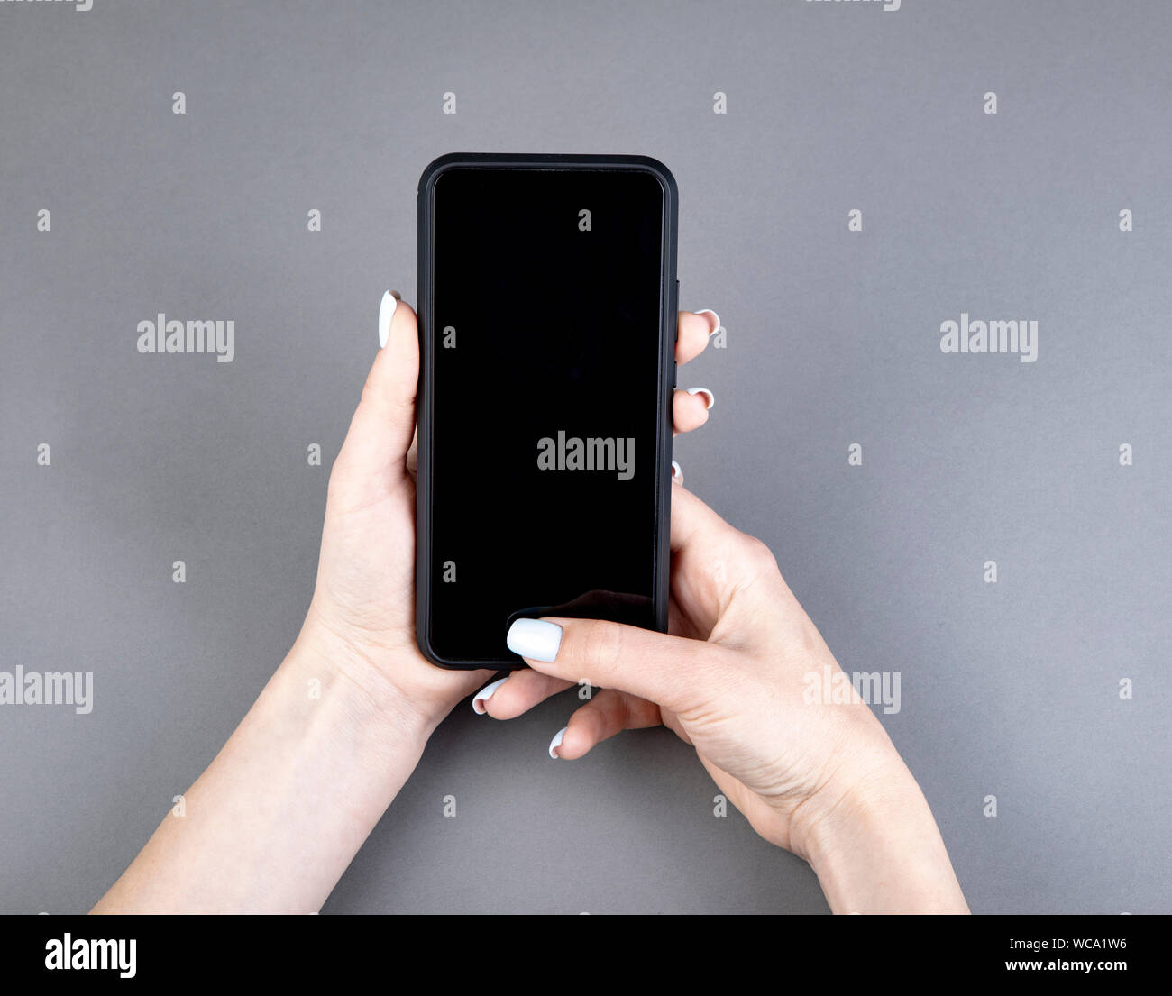 Womans hand holding black screen mobile phone Stock Photo