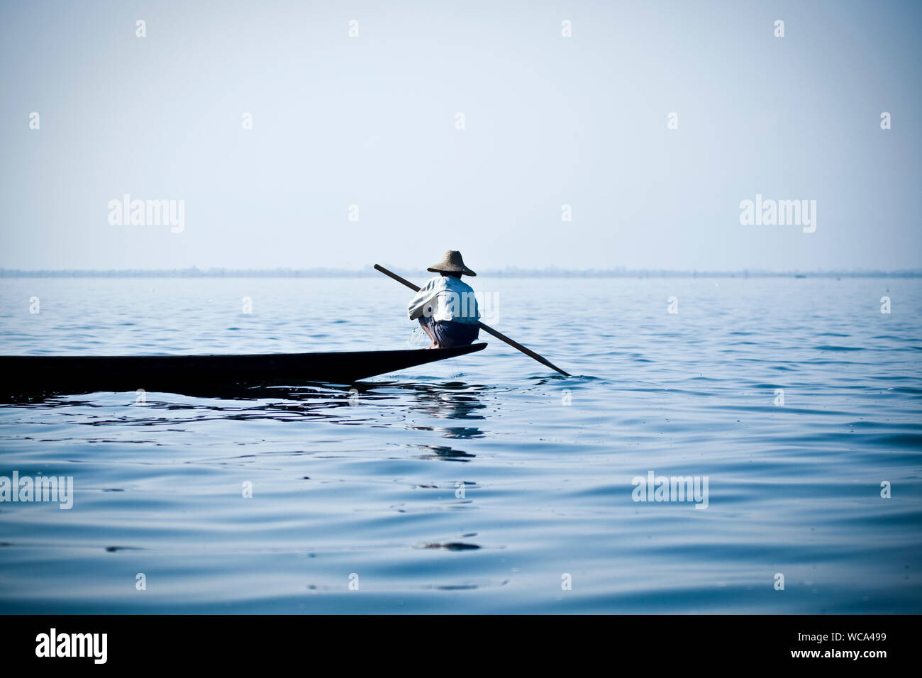 Man Rowing On Boat Stock Photo