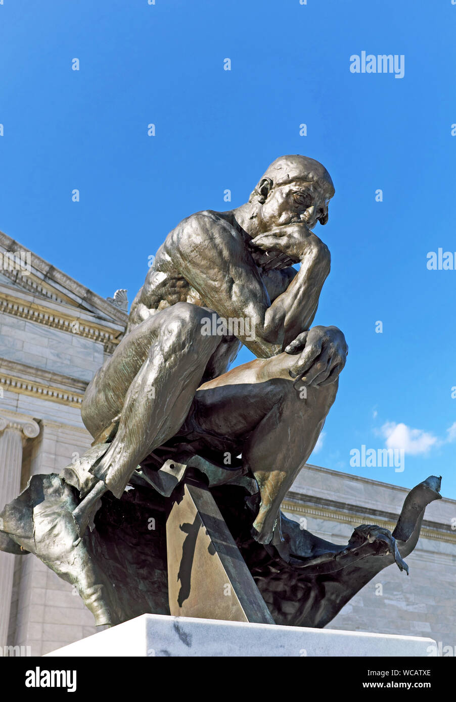 A Rodin-supervised cast of The Thinker, damaged in 1970 by a bomb, sits in front of the south entrance of the Cleveland Museum of Art in Cleveland, OH. Stock Photo