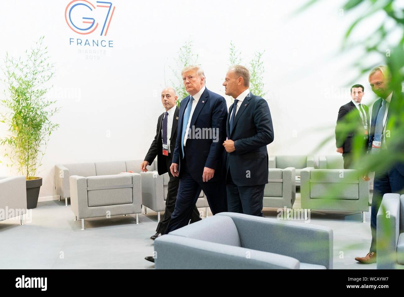 U.S. President Donald Trump, center, walks with European Council President Donald Tusk, right, before the start of a G7 Working Session on the Global Economy, Foreign Policy and Security Affairs at the Centre de Congrés Bellevue August 25, 2019 in Biarritz, France. Stock Photo