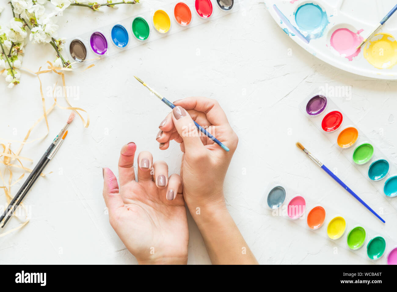 Artist paint brushes and watercolor paintbox on wooden background with  empty sheet of paper. Instruments and tools for creative leisure. Paintings  art Stock Photo - Alamy