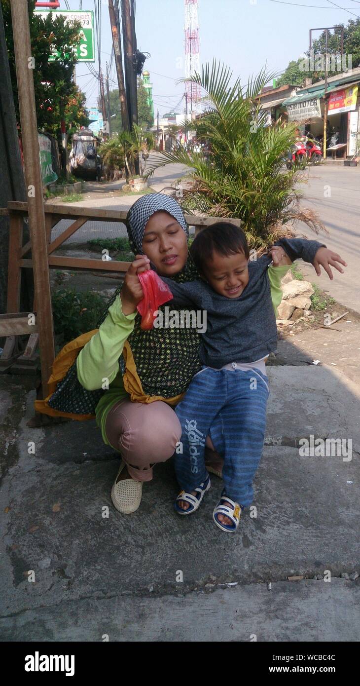 Indian woman holding child hi-res stock photography and images - Alamy