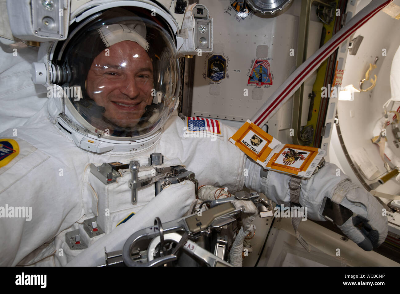 NASA astronaut Andrew Morgan wearing his spacesuit in the Quest Airlock onboard the International Space Station August 21, 2019 in Earth Orbit. Morgan and fellow astronaut Nick Hague spent six-hours and 32-minutes on a spacewalk to install the second commercial crew vehicle docking port, to accommodate the future arrivals of Boeing CST-100 Starliner and SpaceX Crew Dragon commercial crew spacecraft. Stock Photo