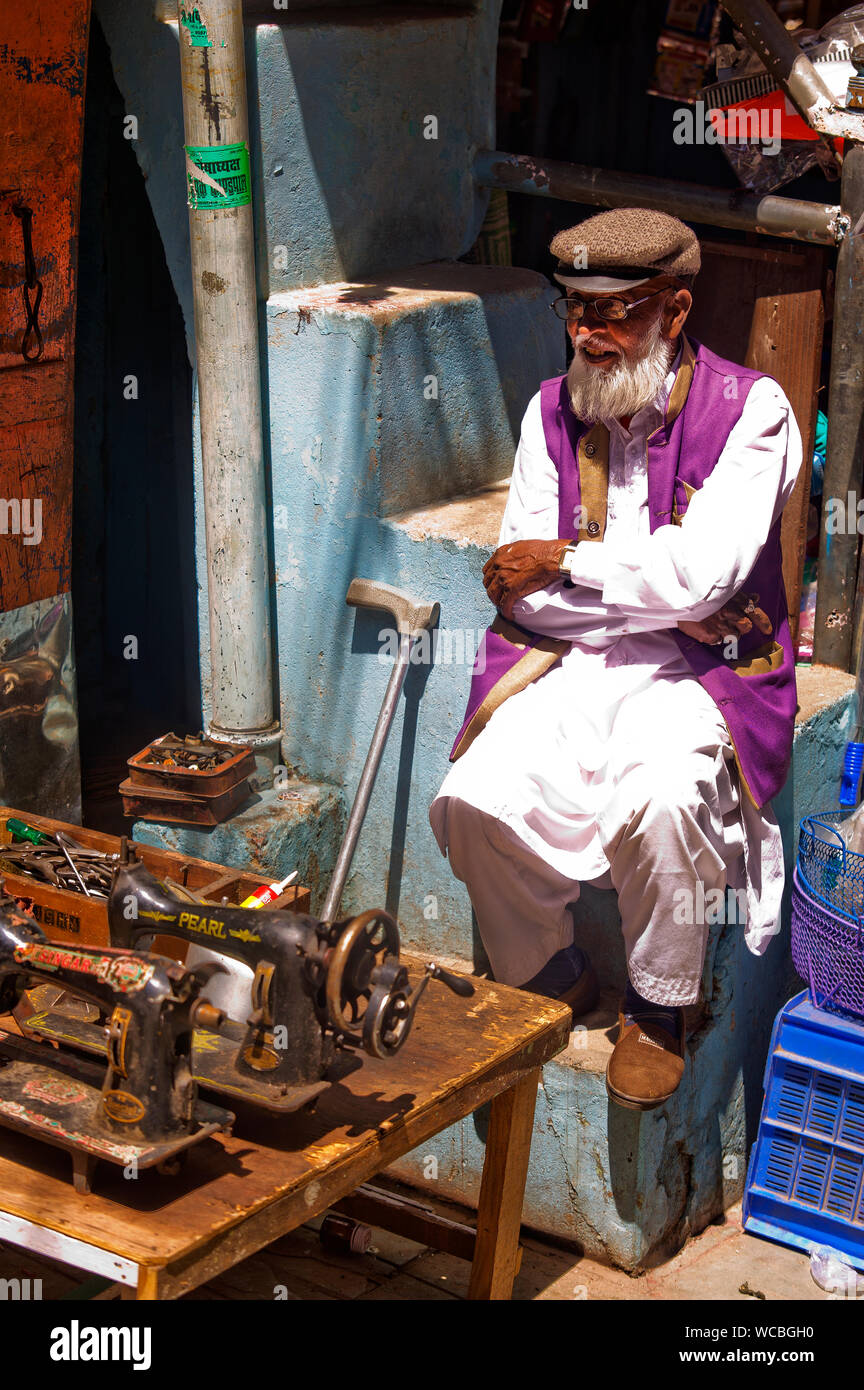 Old indian man selling used sewing machines at the market at Almora town, Uttarakhand, India Stock Photo