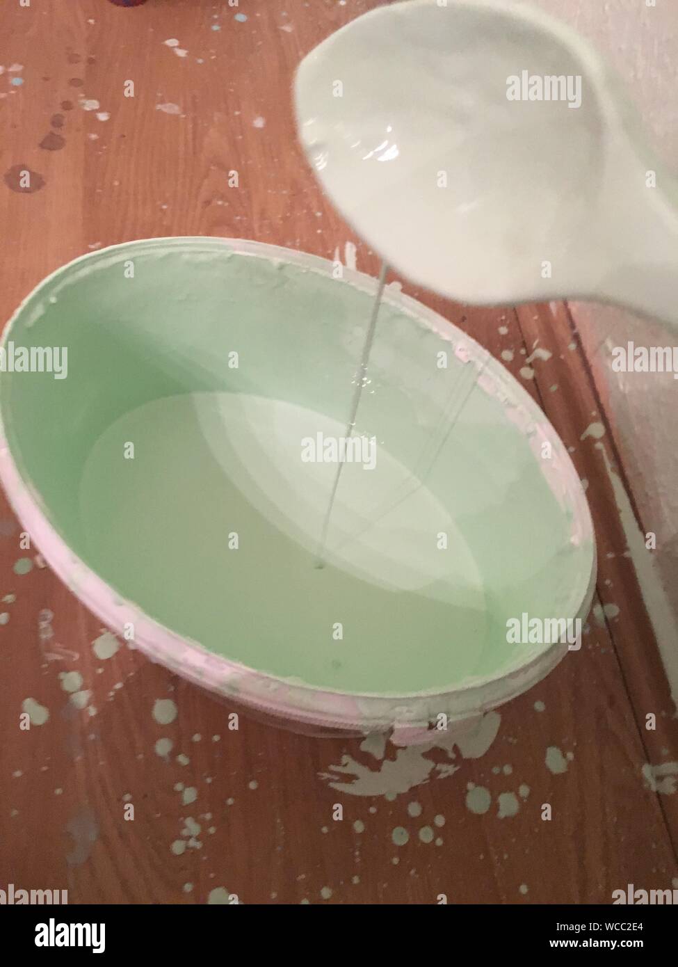 Paint Dropping In Mixing Bowl Stock Photo