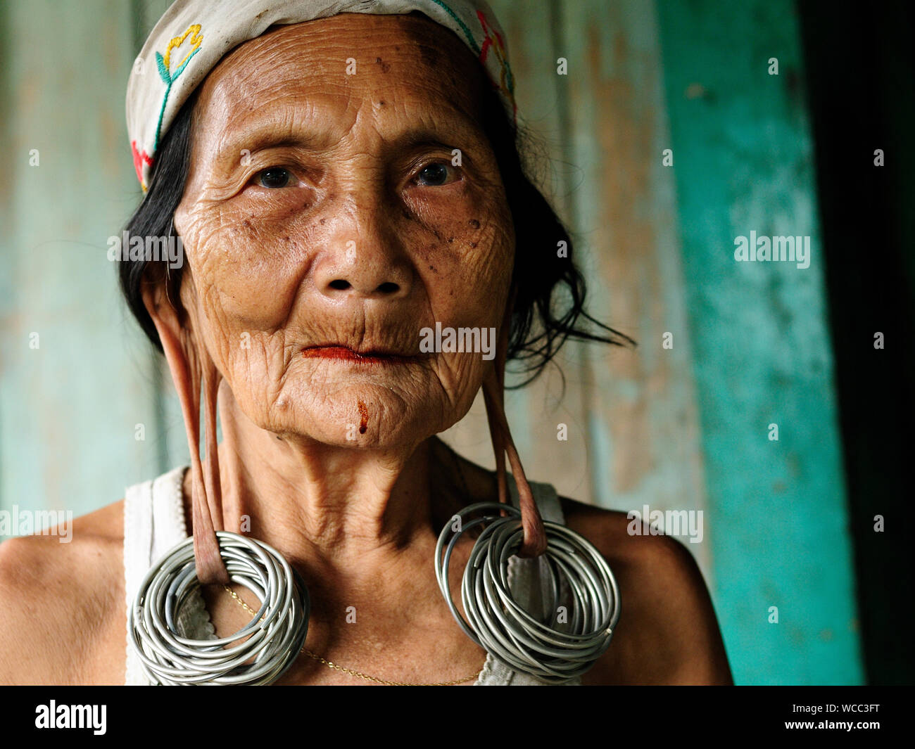 LONG BAGUN, BORNEO, INDONESIA - JULY 07: The older Dayak women with traditional long earlobes and tattoo from Borneo Stock Photo