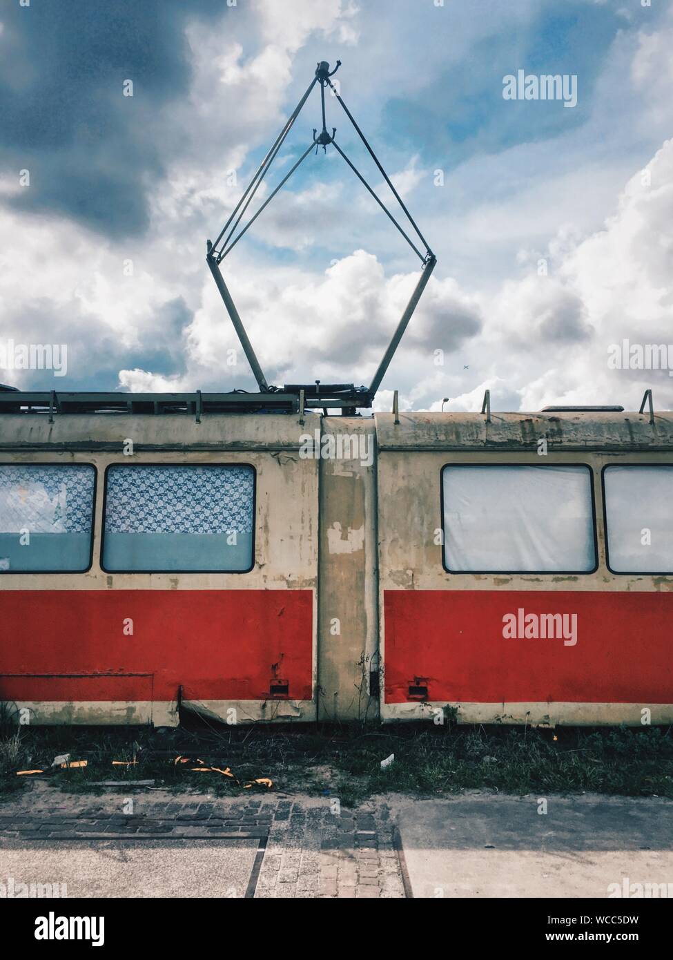 Abandoned Tram Against Cloudy Sky Stock Photo