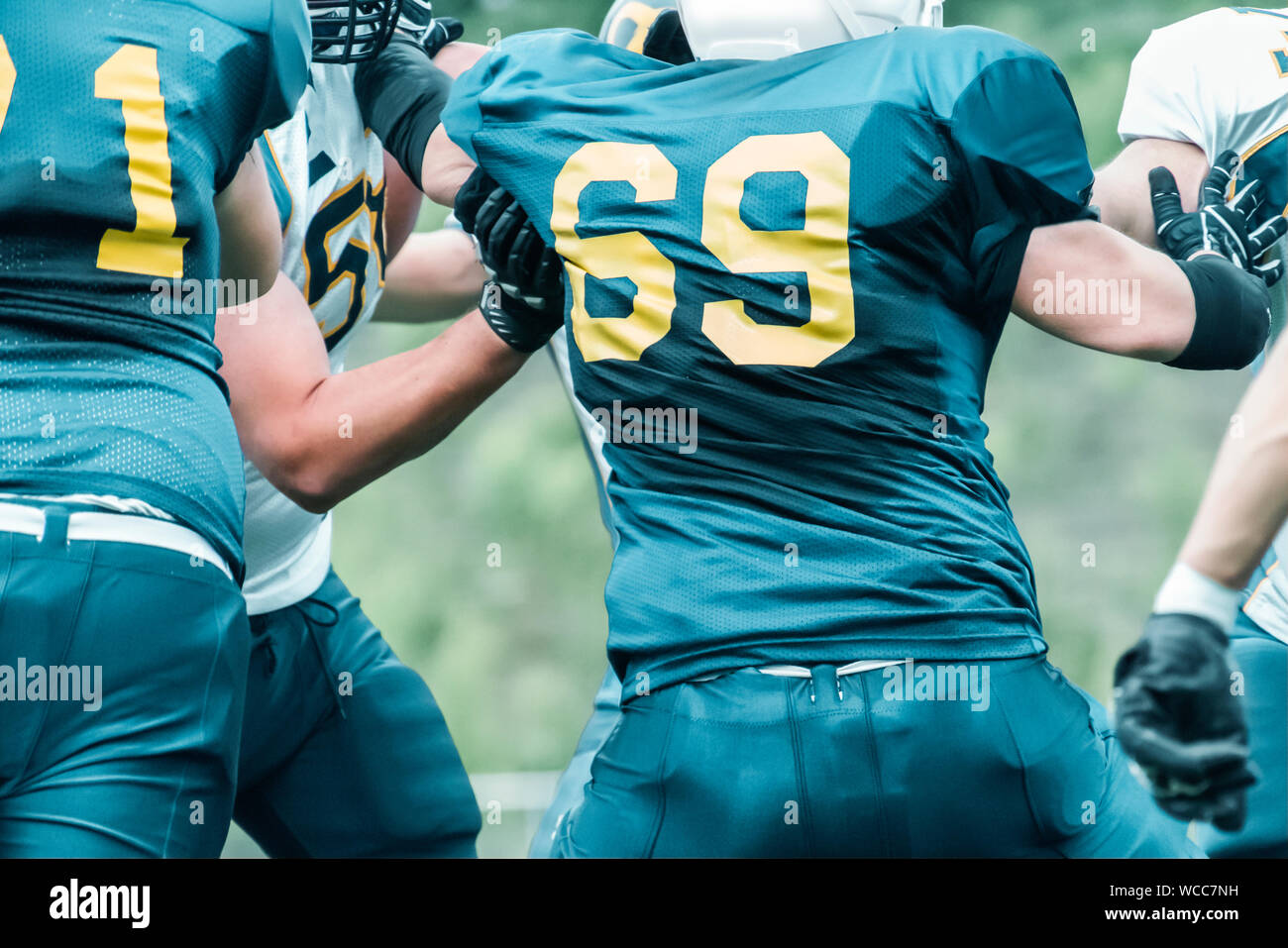 Midsection Of People Playing American Football Stock Photo