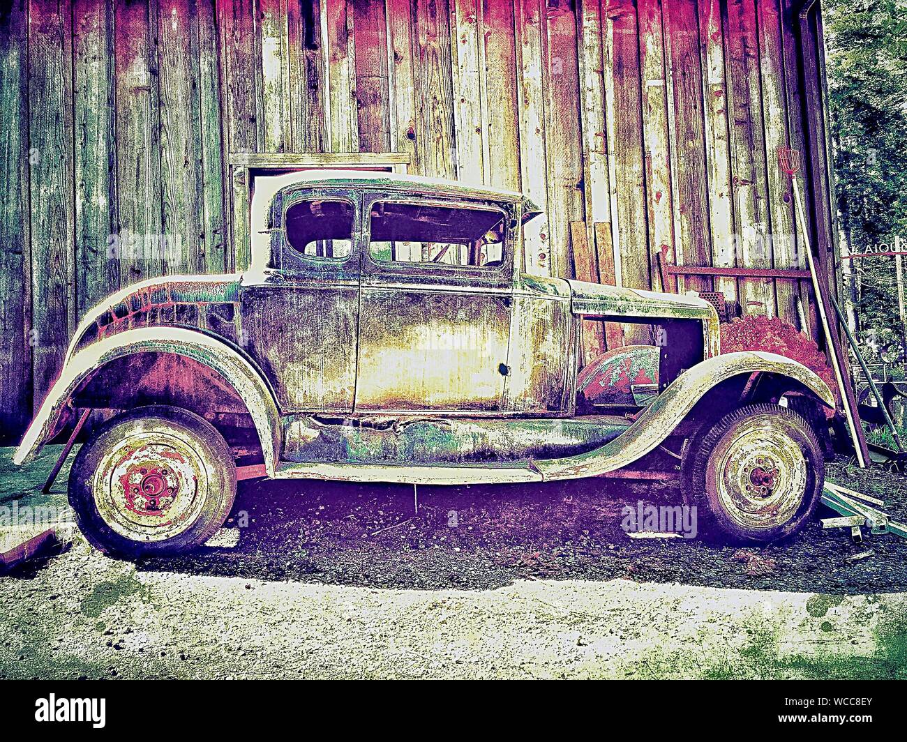 Abandoned Vintage Car By Building Stock Photo - Alamy