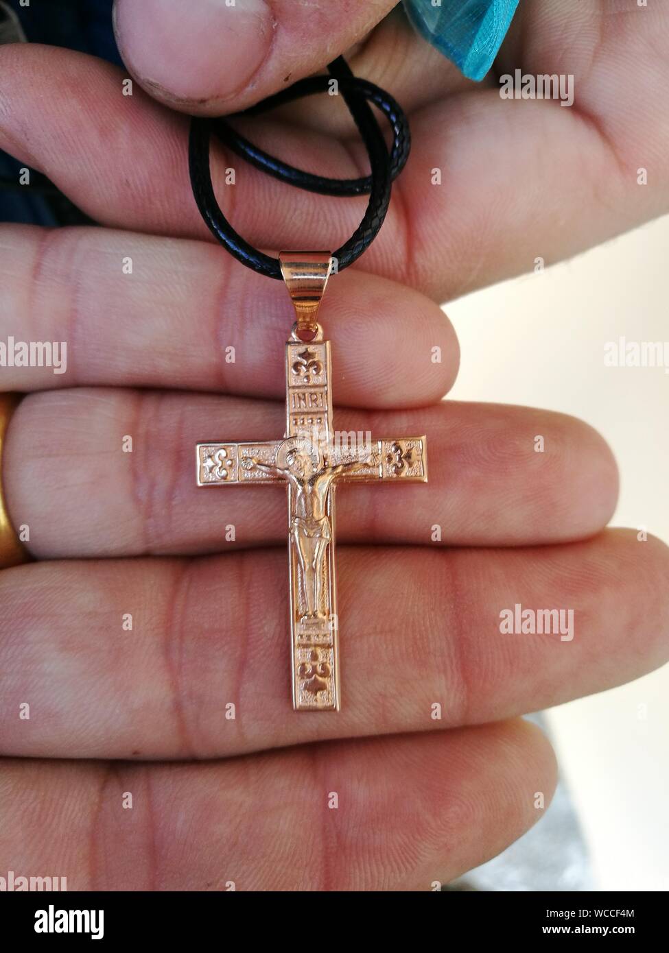 Close-up Of Human Hand Holding Religious Cross Stock Photo
