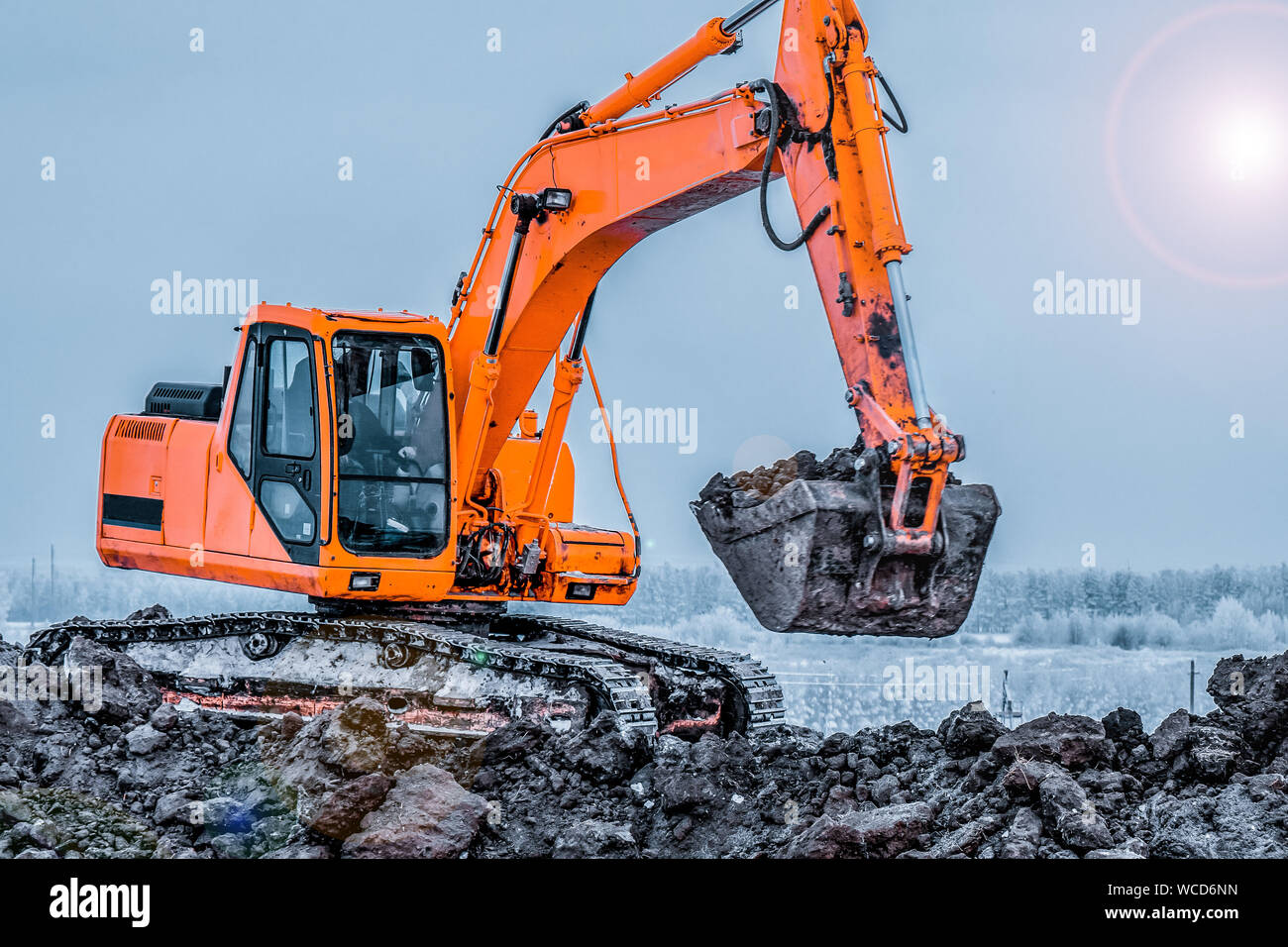 Excavator is loading excavation to the truck. Excavators are heavy