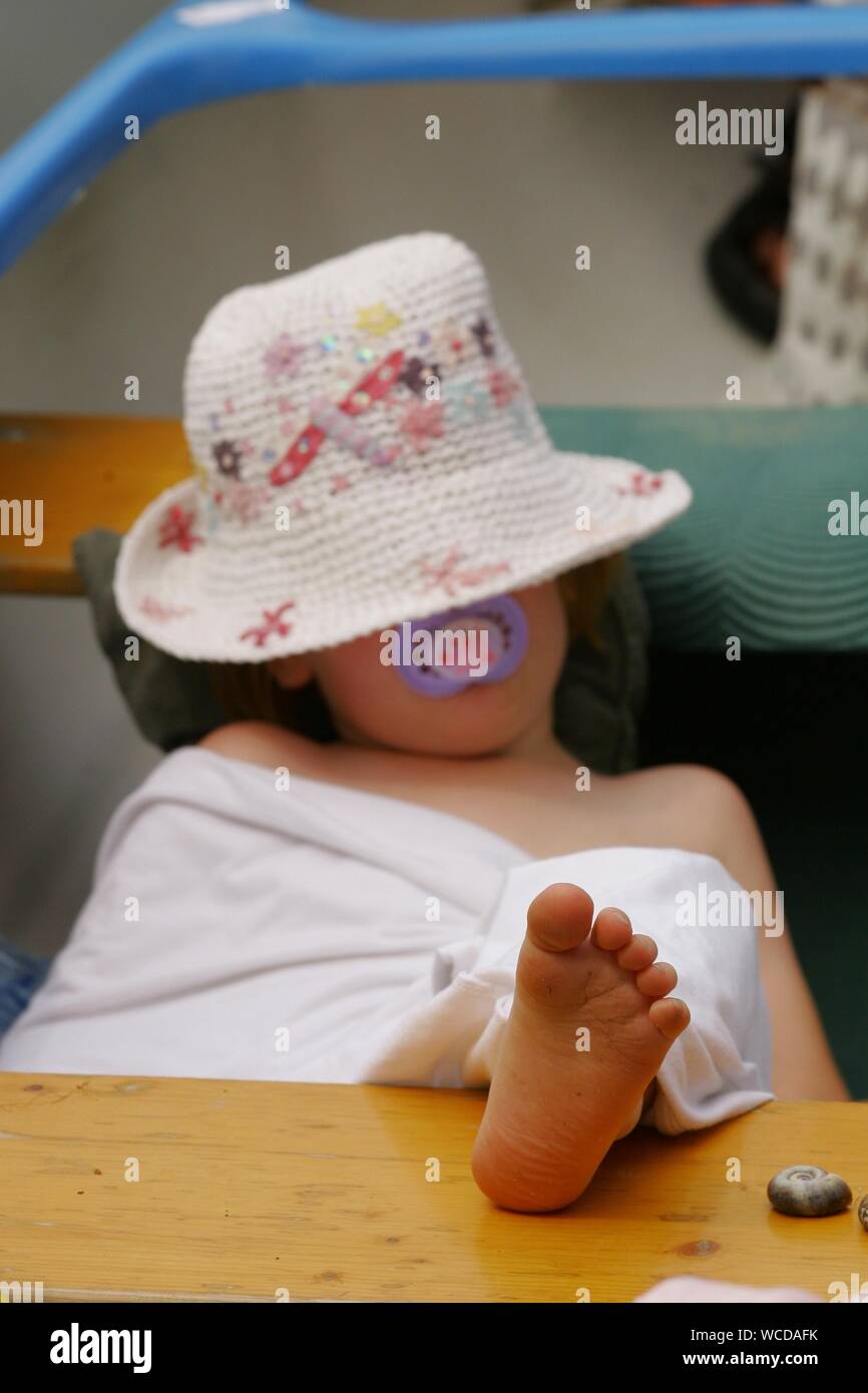 Girl Sleeping With Feet Up On Table At Home Stock Photo Alamy
