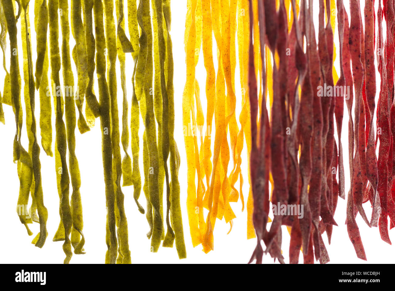 Various types of fresh homemade pasta. Raw pasta drying process