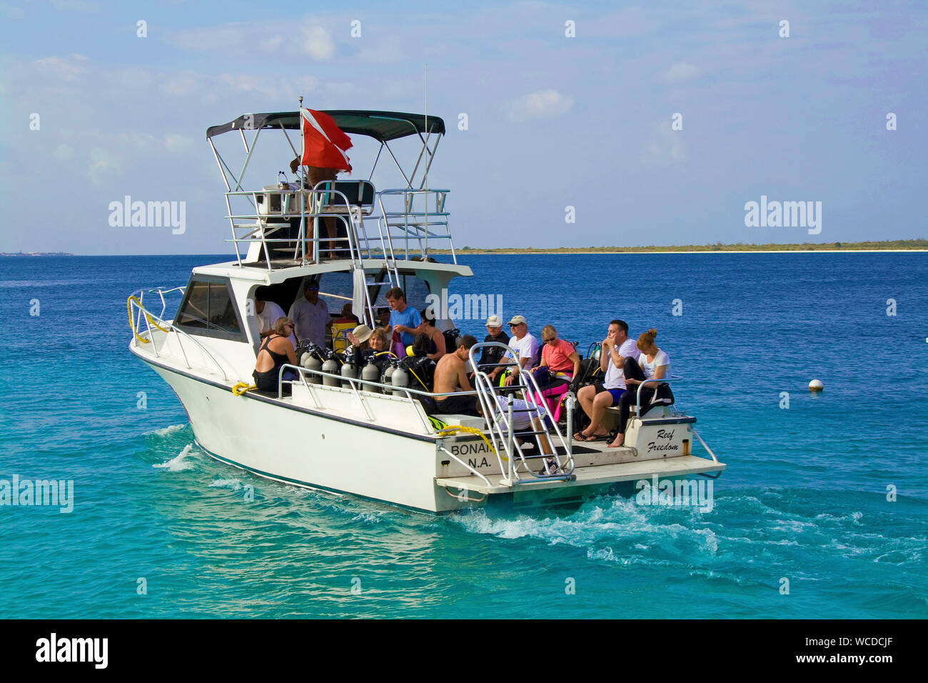 Dive vessel with scuba diver, boats trip to Little Bonaire, Captain Don's Habitat, Resort and Diving hotel, Kralendijk, Bonaire, Netherland Antilles Stock Photo