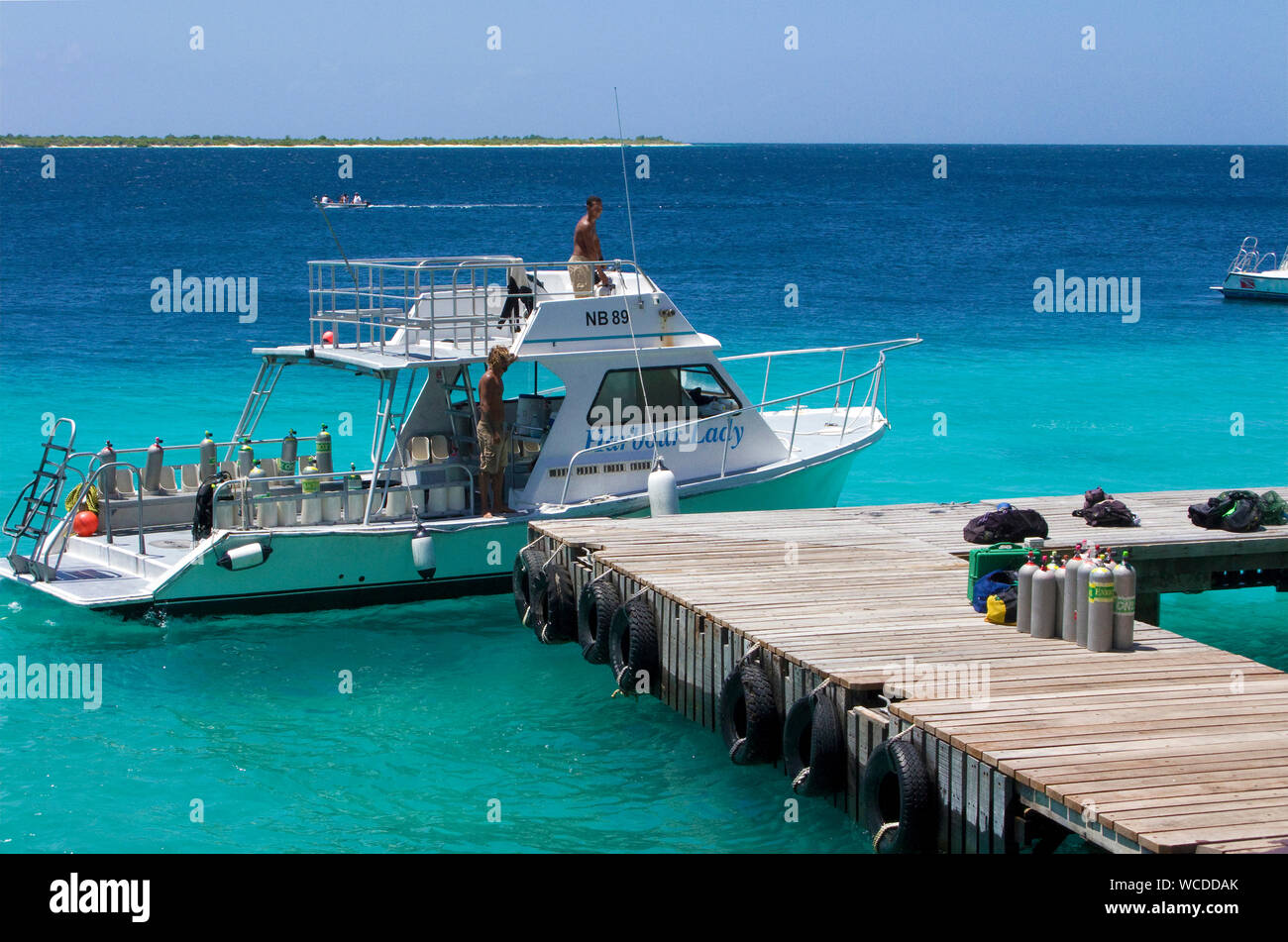 Dive boat at jetty of Buddy Dive Resort, popular Dive hotel on Bonaire, Netherland Antilles Stock Photo