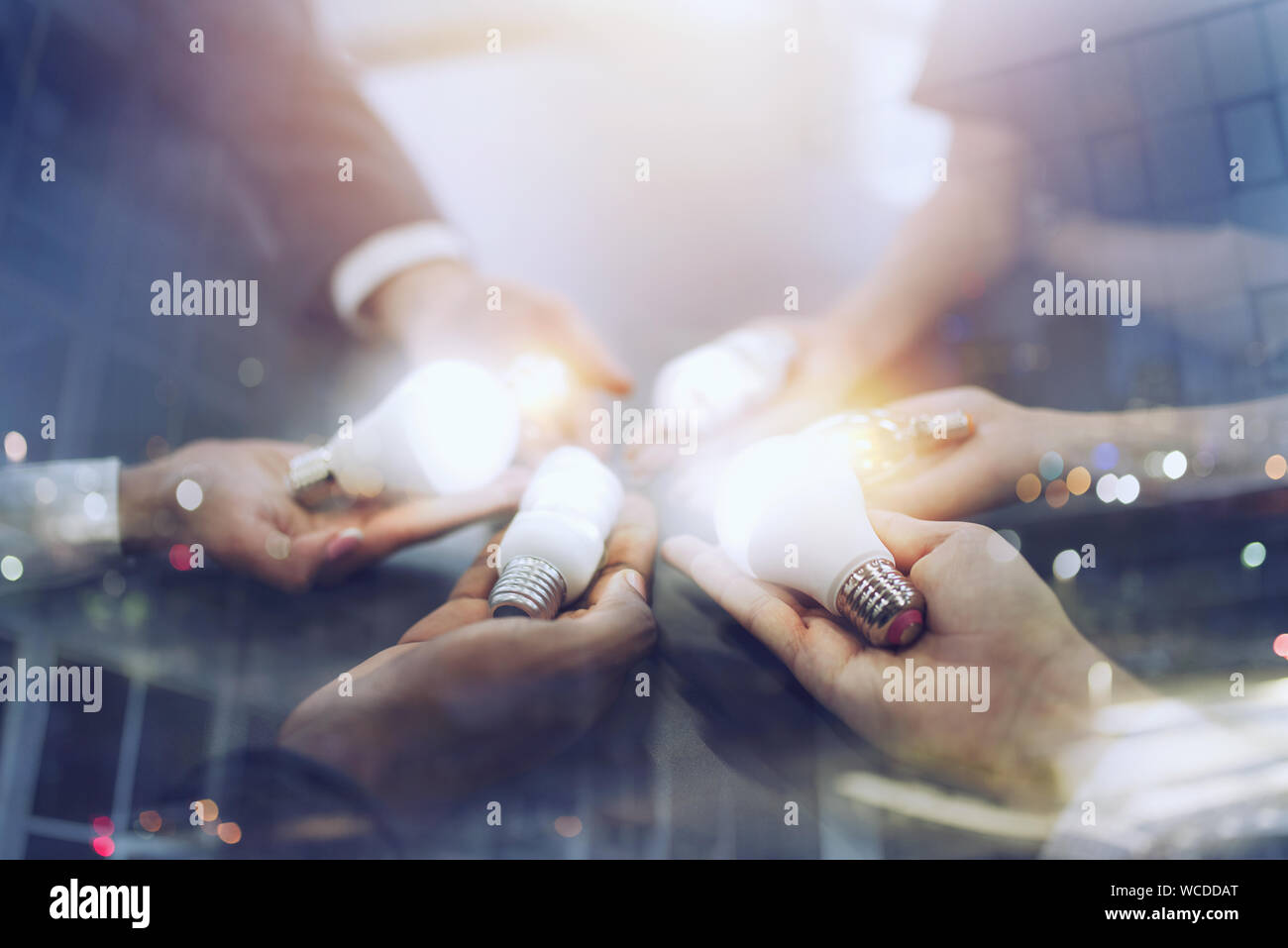 Teamwork and brainstorming concept with businessmen that share an idea with a lamp. Concept of startup Stock Photo