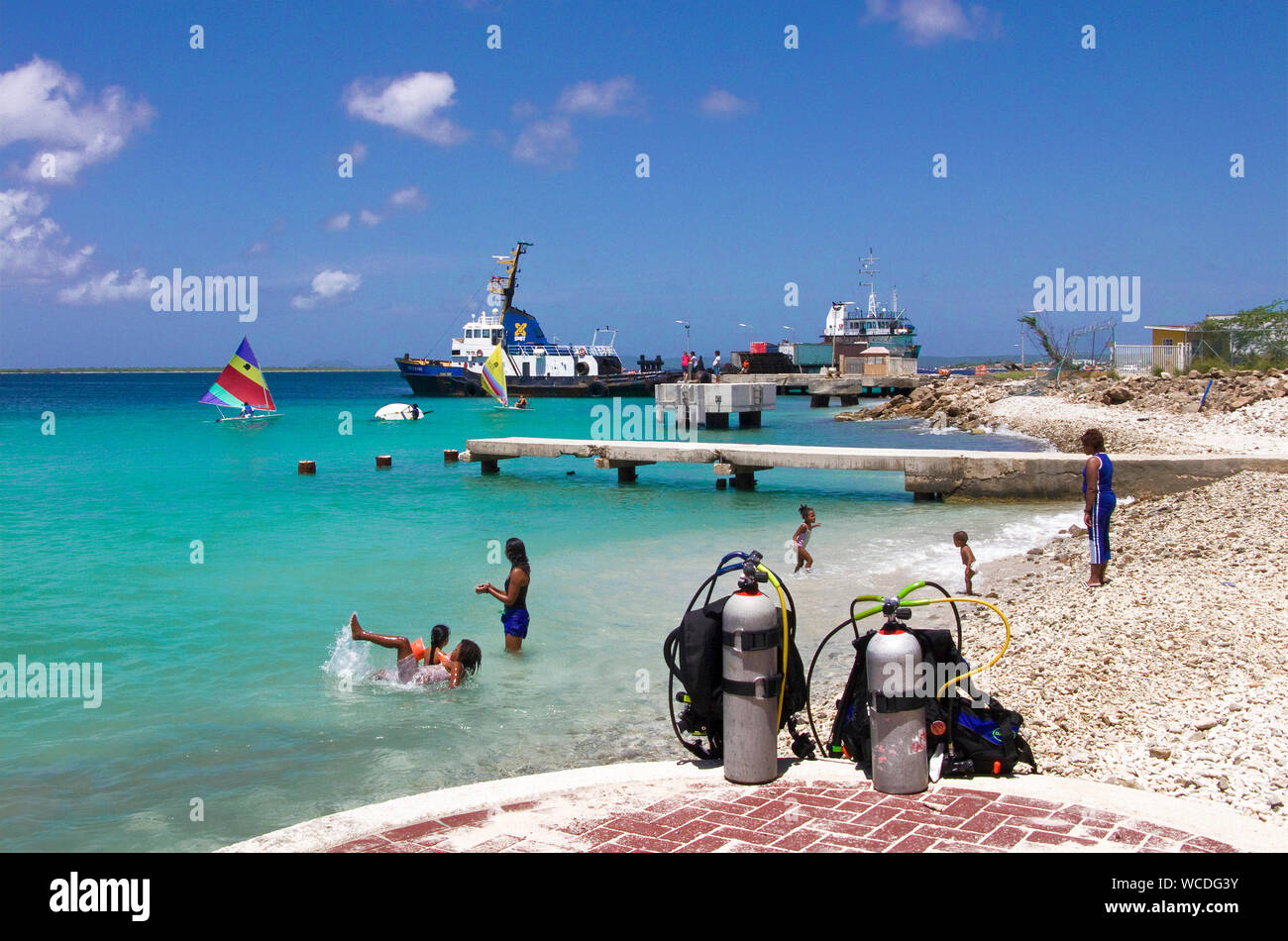 Diving cylinders at the baech, surfer on the sea, Watersport paradise Bonaire, Netherland Antilles Stock Photo