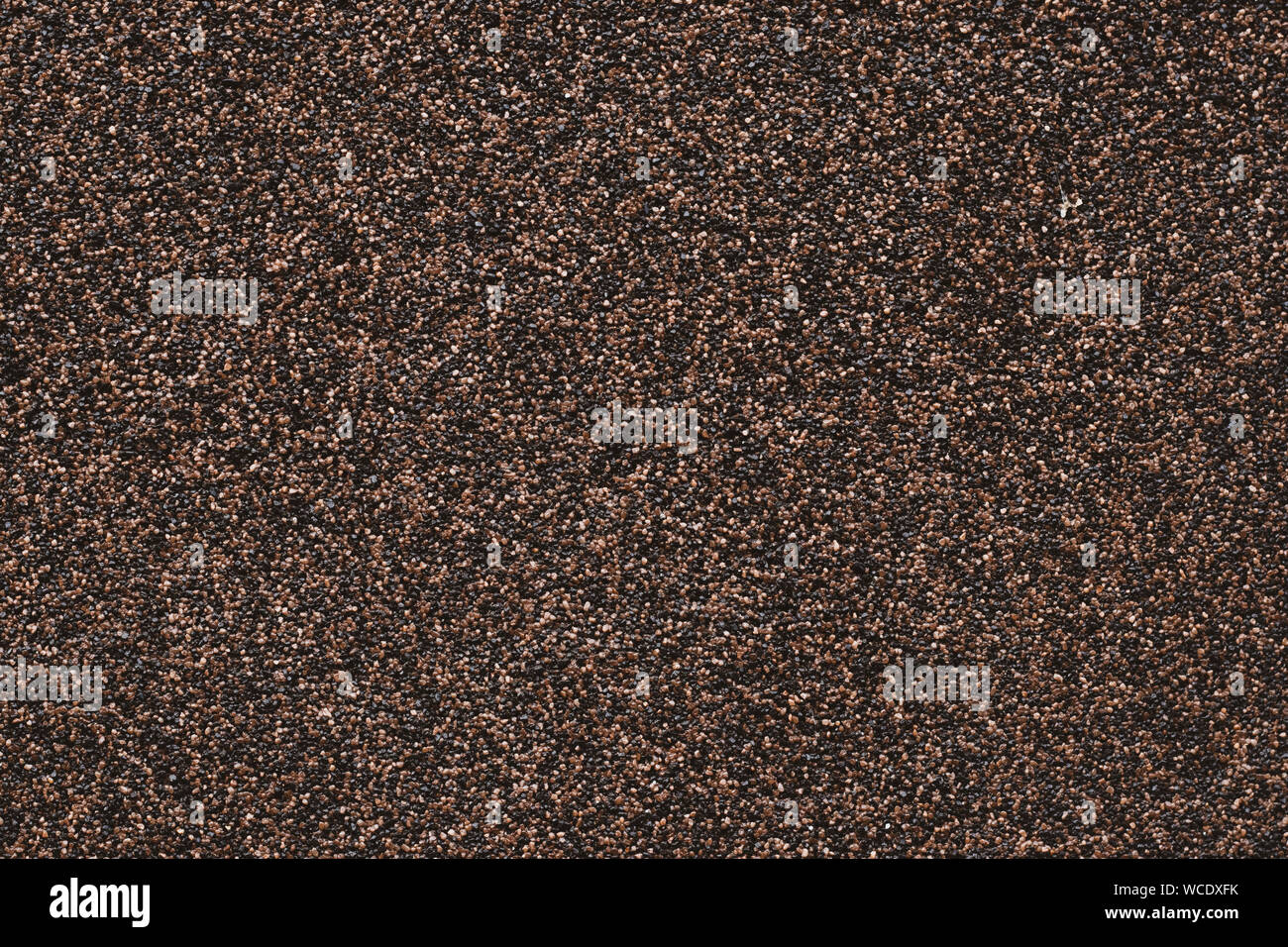 Background of small black pebbles. Modern paper design. Abstract grains pattern. Brown mottled texture of wall. Stone motley surface. Grunge floor Stock Photo