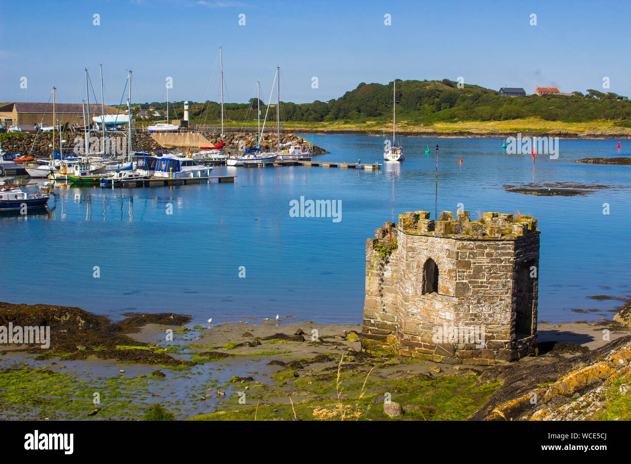 8 August 2019 A small medieval stone tower overlooking the marina and harbour at Ardglass County Down northern Ireland on a hot day in summer Stock Photo