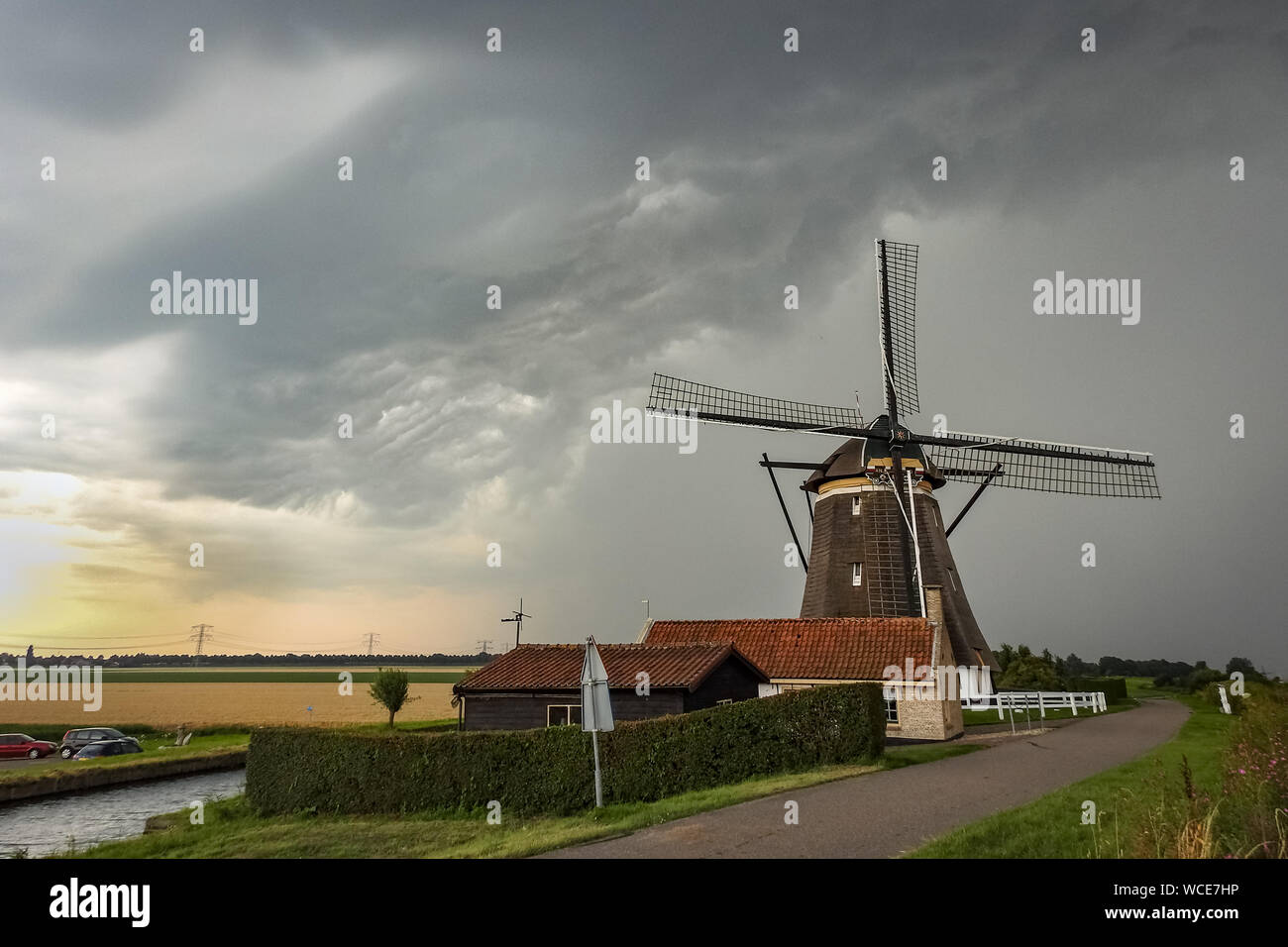 Dutch windmill with an approaching thunderstorm Stock Photo