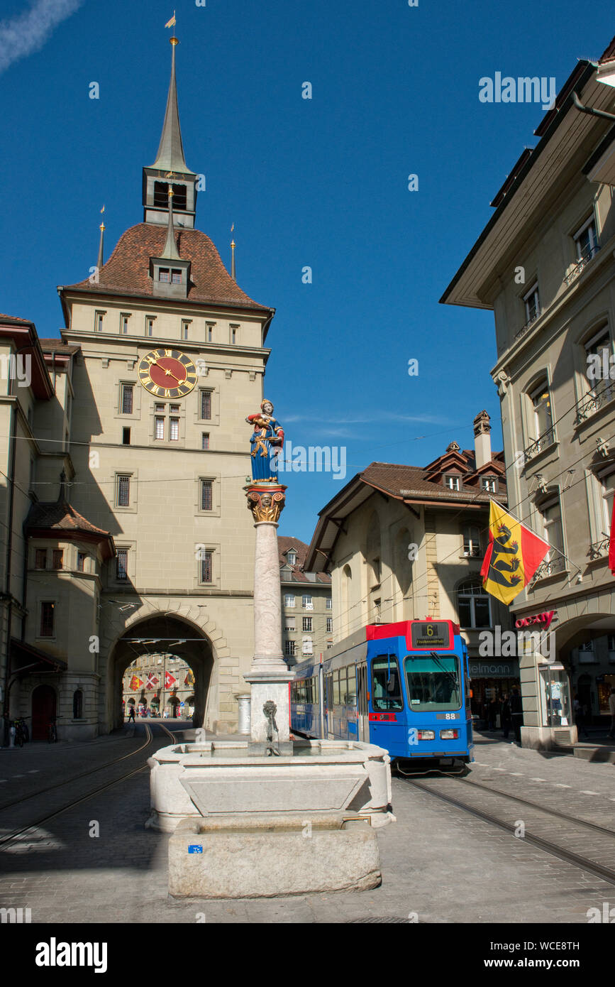 Tram passing the Käfigturm medieval tower and clock. Old Town, Bern, Switzerland Stock Photo