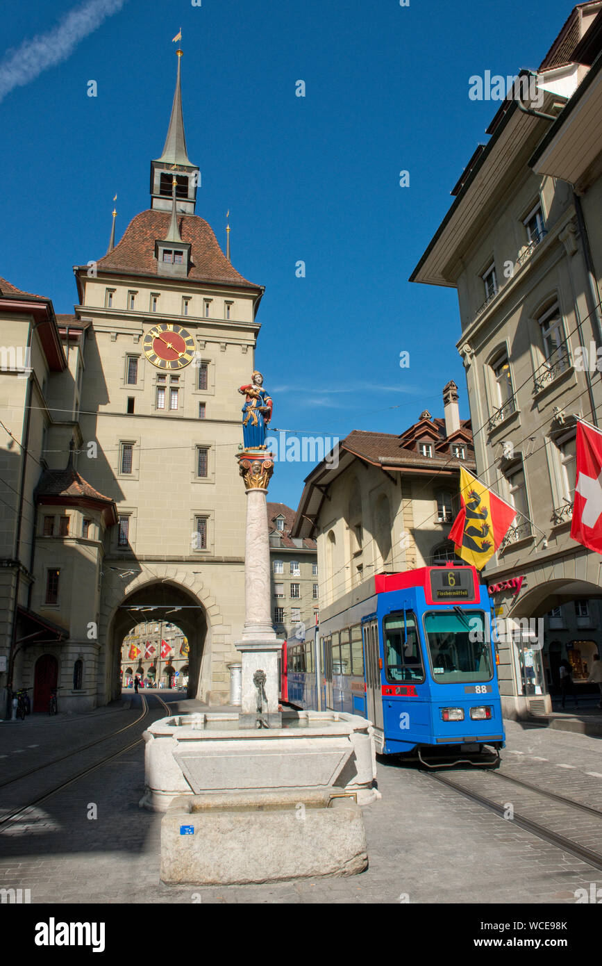 Tram passing the Käfigturm medieval tower and clock. Old Town, Bern, Switzerland Stock Photo