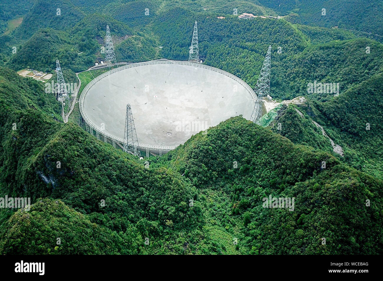 Pingtang. 27th Aug, 2019. Aerial photo taken on Aug. 27, 2019 shows China's Five-hundred-meter Aperture Spherical radio Telescope (FAST) in southwest China's Guizhou Province. China's FAST, the world's largest single-dish radio telescope, will greet the third anniversary of operation that began in September 2016. Credit: Ou Dongqu/Xinhua/Alamy Live News Stock Photo
