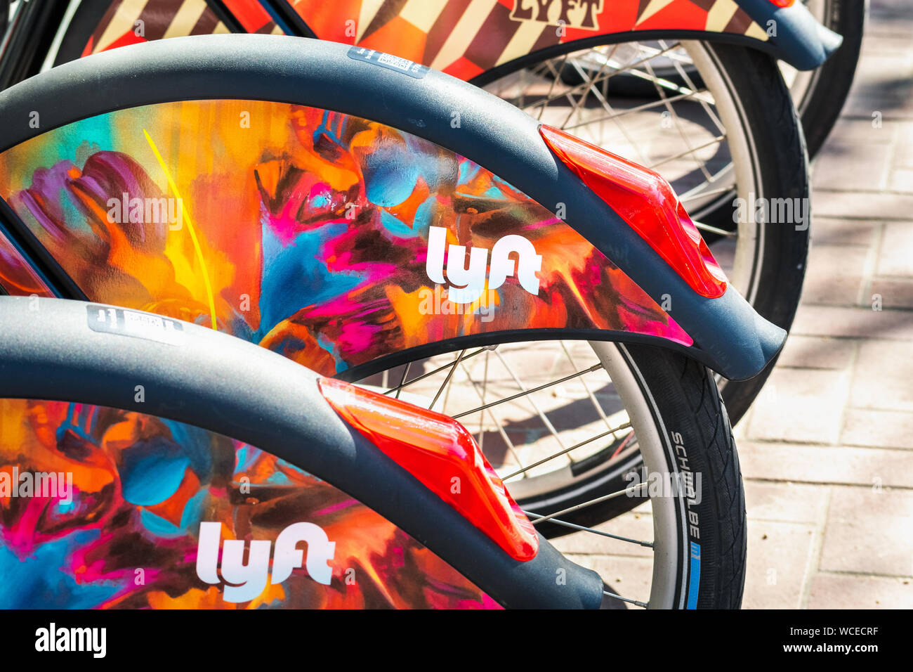 Aug 21, 2019 San Francisco / CA / USA - Close up of Lyft logo on a Bay Wheels bicycle wheel parked at a station; Motivate (the Company operating the b Stock Photo