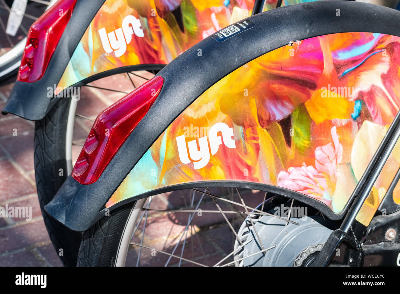Aug 21, 2019 San Francisco / CA / USA - Close up of Lyft logo on a Bay Wheels bicycle wheel parked at a station; Motivate (the Company operating the b Stock Photo