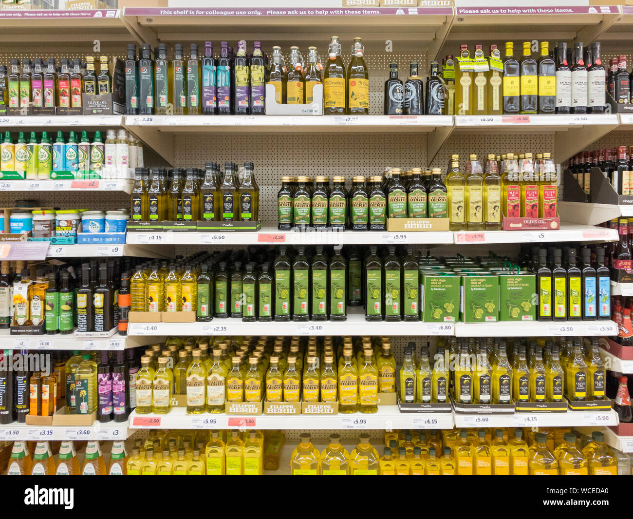 Olive oil for sale on a Sainsbury supermarket shelf, UK Stock Photo