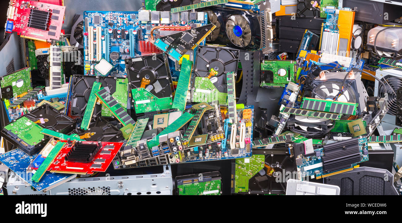 E-waste recycling. Used computer parts. Electronic, plastic and metal refuse. Big colorful pile of discarded or obsolete laptop and PC components. Stock Photo