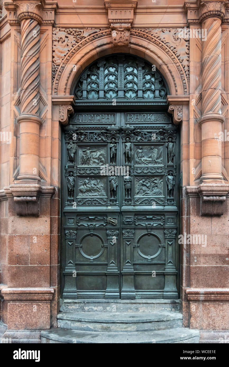 An elaborate bronze door on an old Adelphi Bank in Liverpool, now a trendy coffee shop Stock Photo