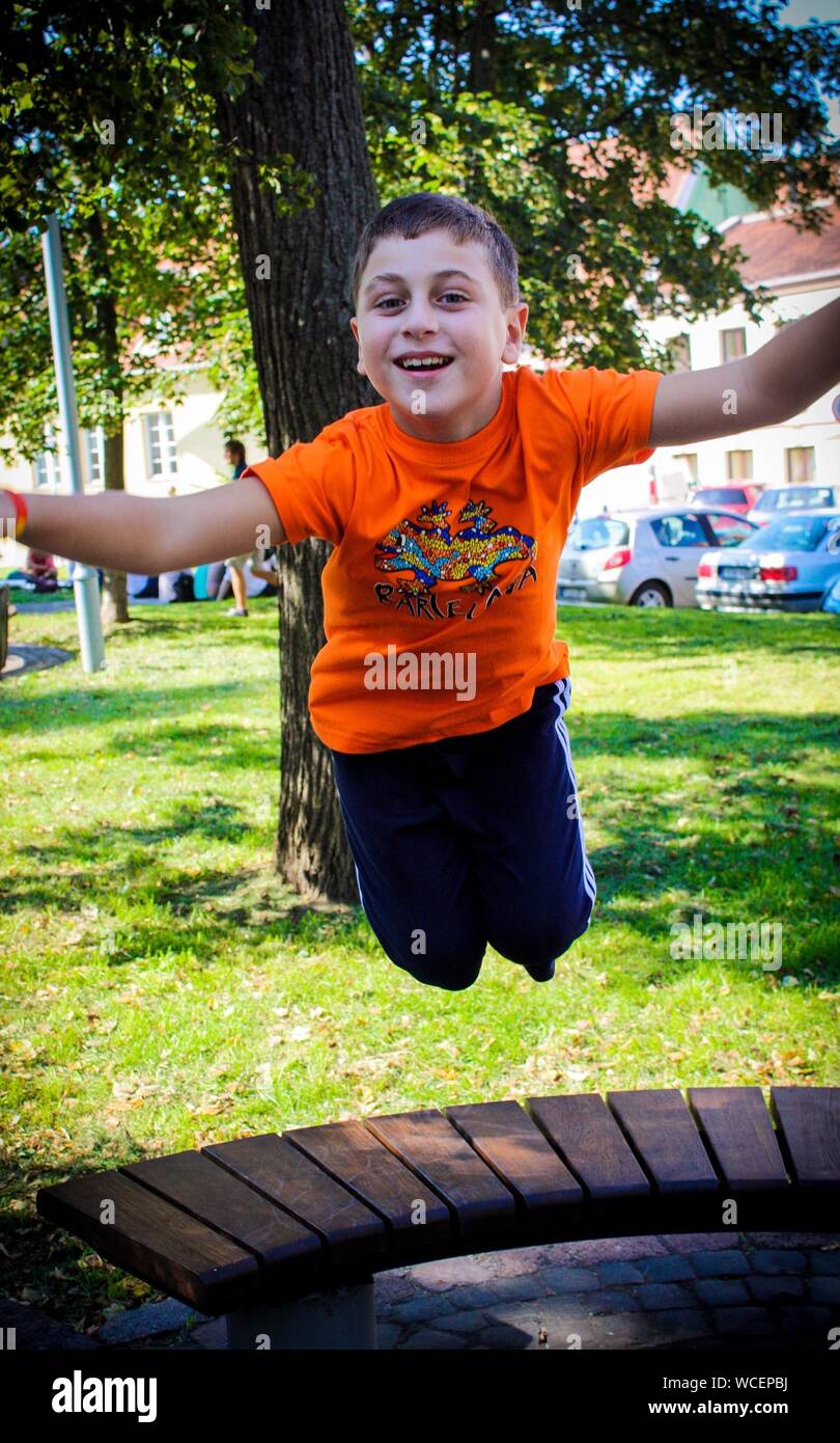 Children jumping in air in park hi-res stock photography and images - Alamy