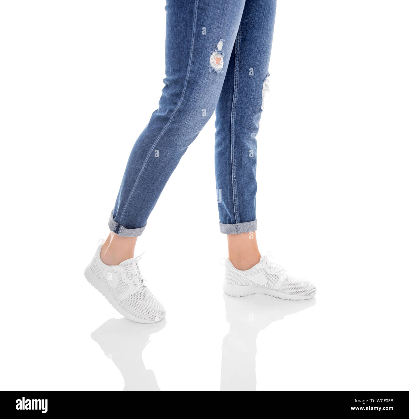 Legs in jeans and white sneakers isolated on a white background Stock ...