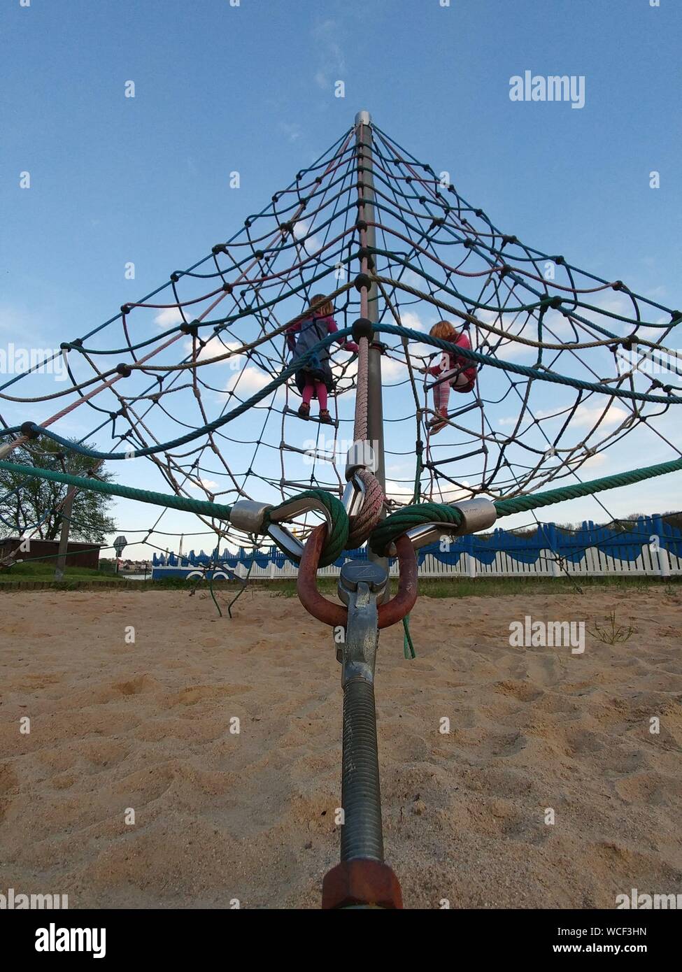 Low Angle View Of Kids Playing On Play Equipment At Park Stock Photo