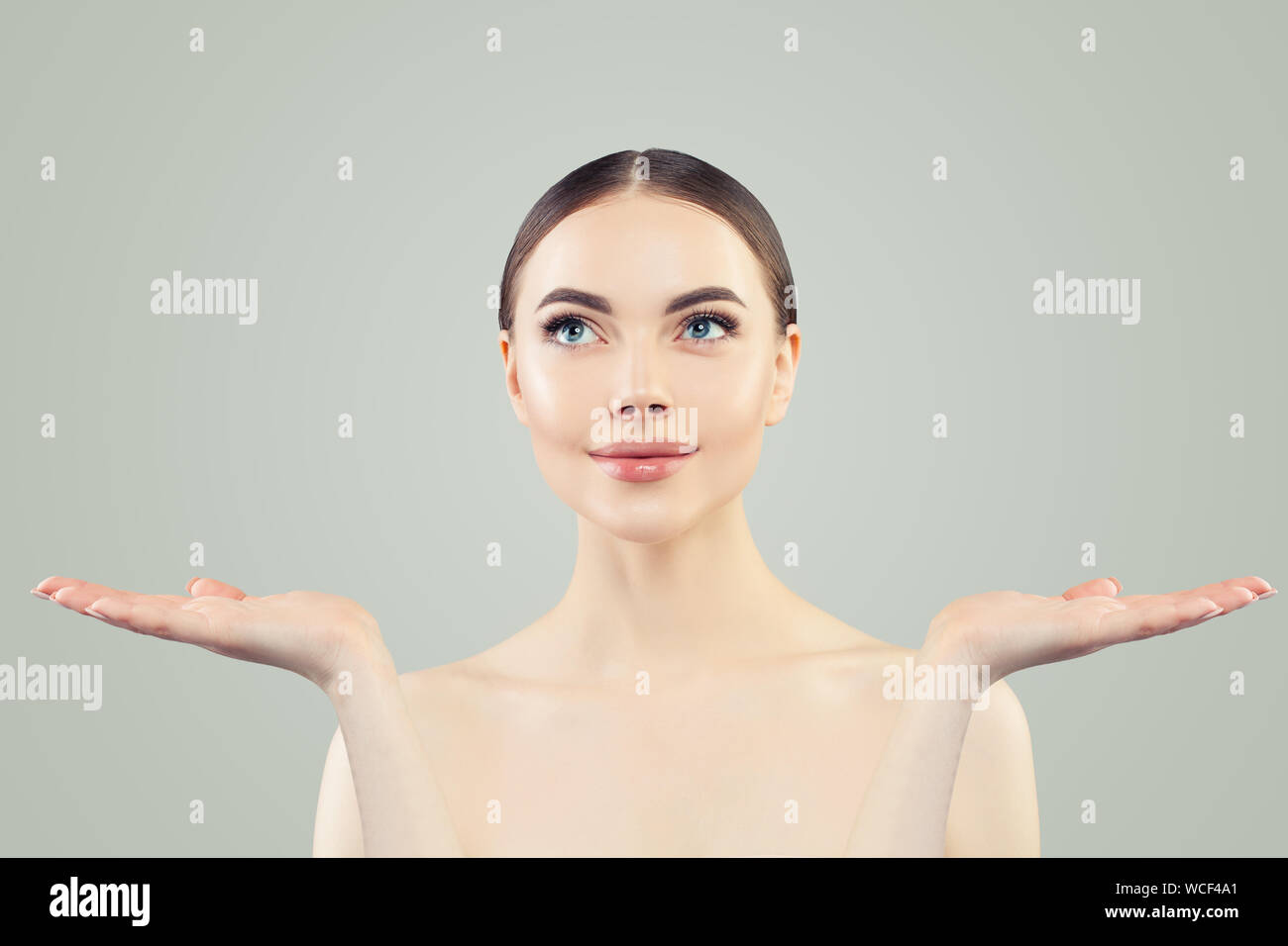 Beautiful woman showing empty copy space on two open hands Stock Photo ...