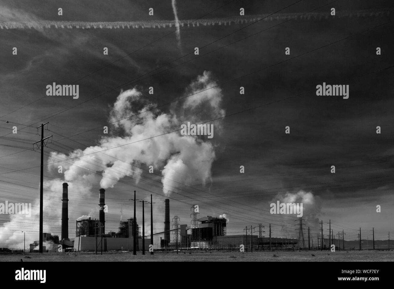 Smoke Stack Emitting Pollution From Factory Against Sky Stock Photo