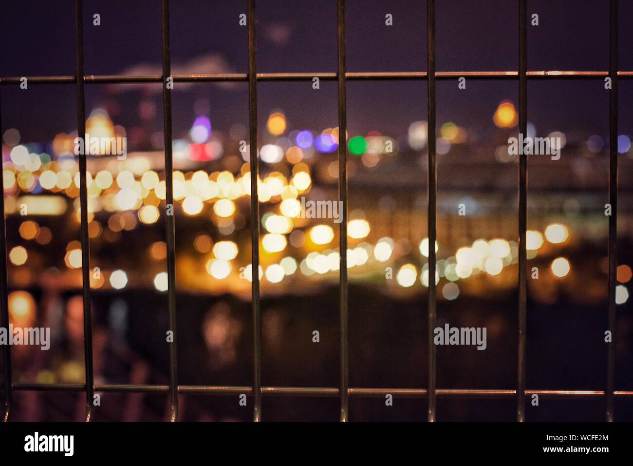 High Angle View Of Illuminated Lights In City Seen Through Window At Night Stock Photo Alamy