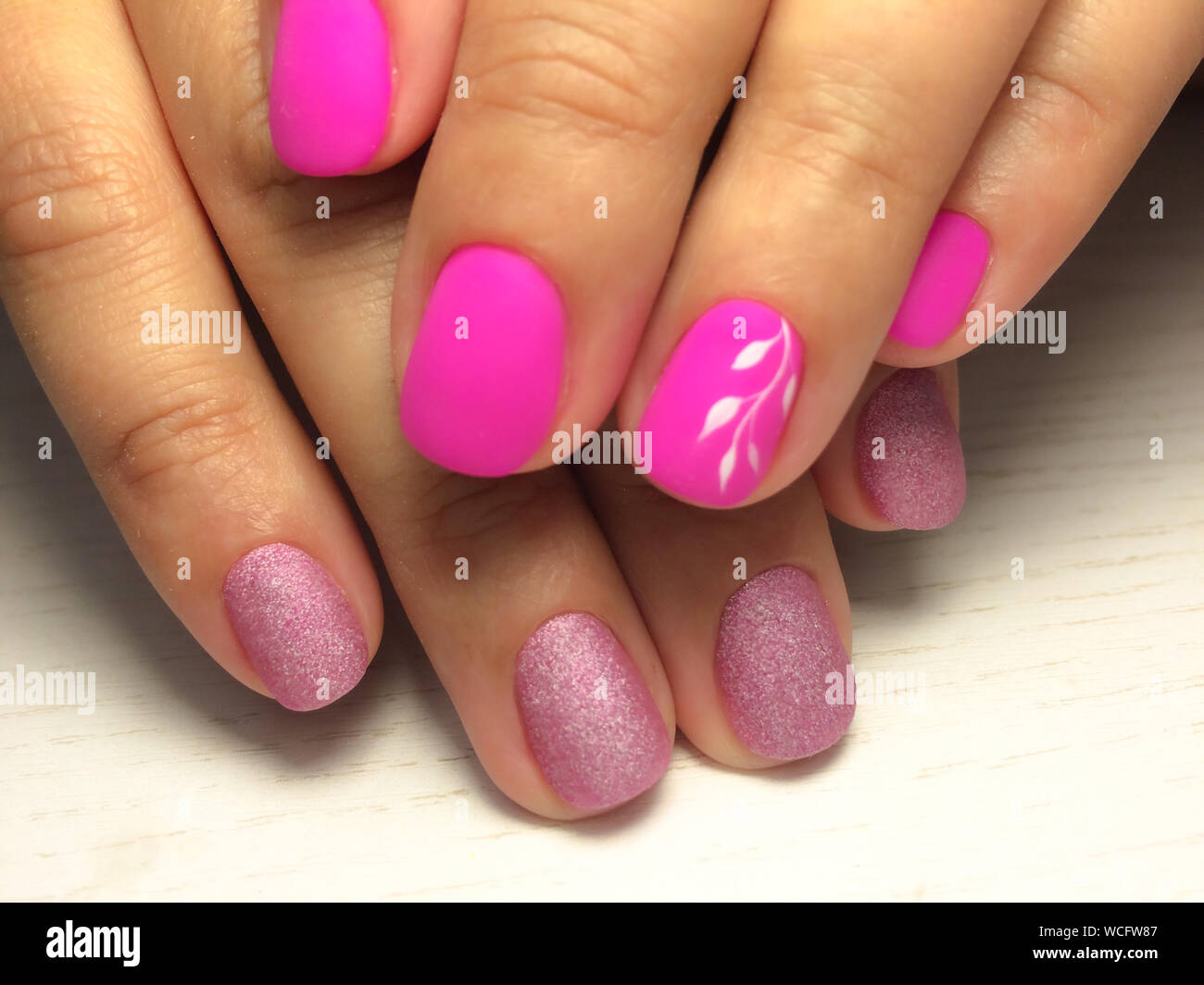 Nails care. Woman hands with pink manicure. Closeup photo. Beauty
