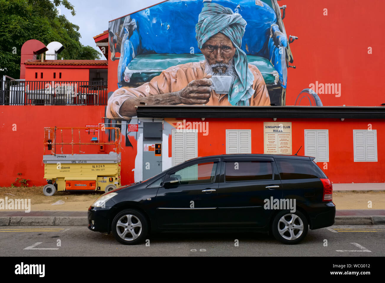 A wall painting in Little India, Singapore, depicting a tea drinking Indian man Stock Photo