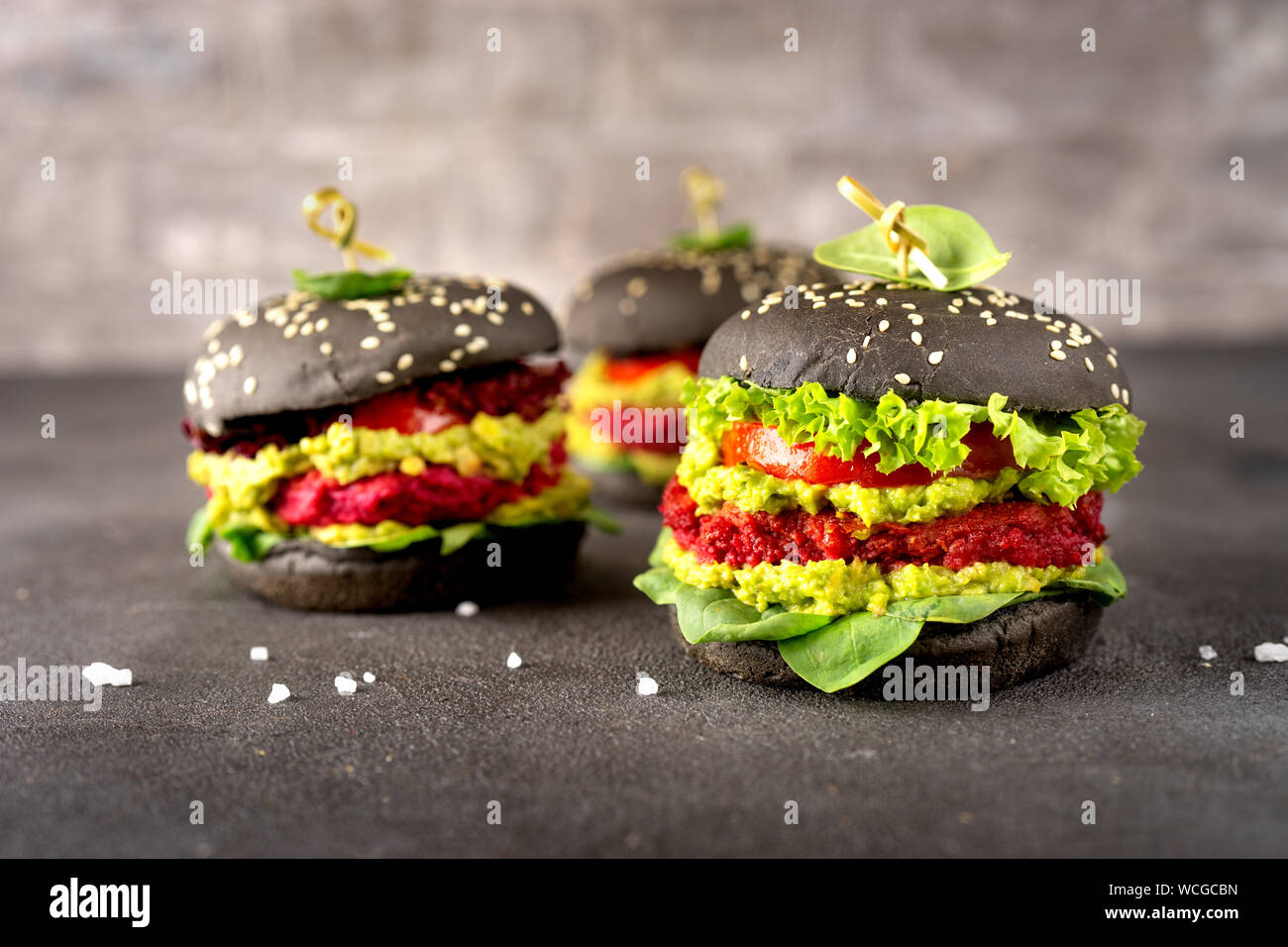 Vegan black burgers with beet patties on dark background Stock Photo