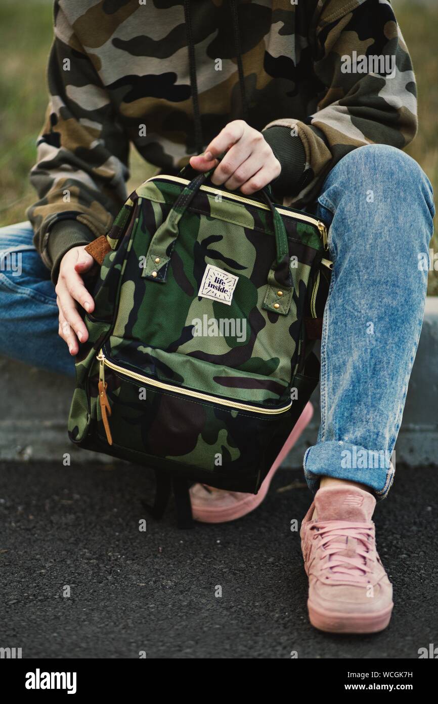 pink sneakers holding a backpack Stock 