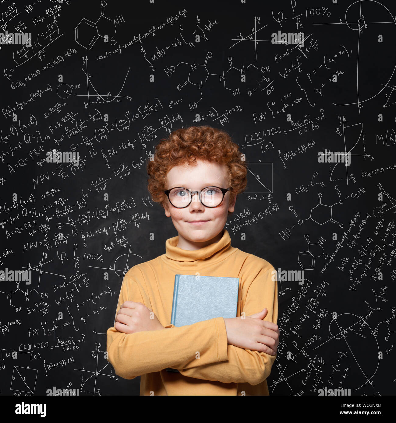 Portrait of clever school boy with red ginger hair on science background. Learn science concept Stock Photo