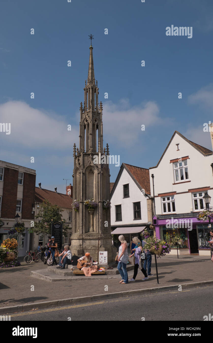 Busker in Glastonbury Village centre in somerset in summer Stock Photo Alamy
