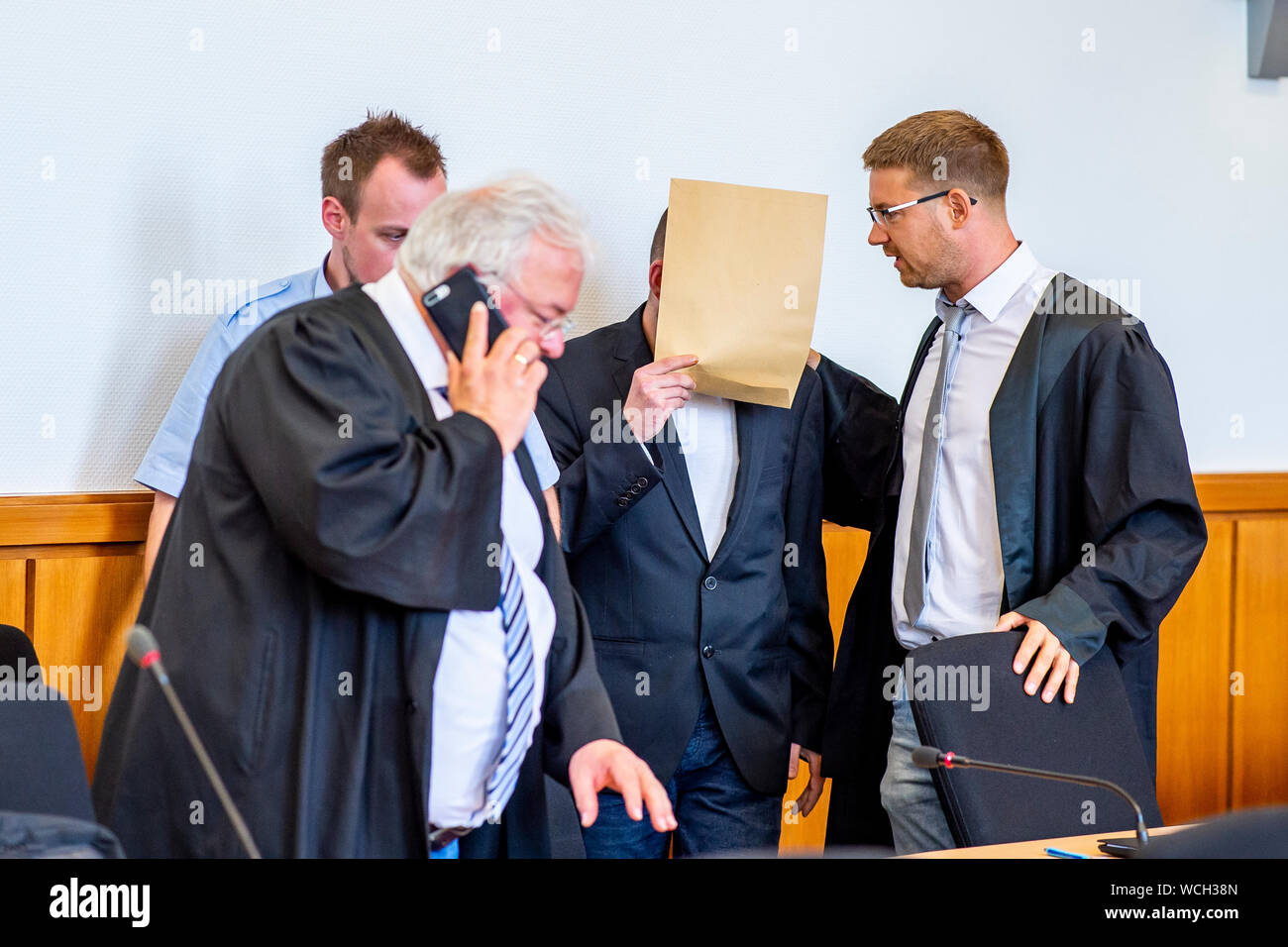 Hagen, Germany. 28th Aug, 2019. The defendant Sven S. is led into the courtroom by a judicial officer and converses with his defender Nikolai Odebralski (right). Credit: David Inderlied/dpa/Alamy Live News Stock Photo