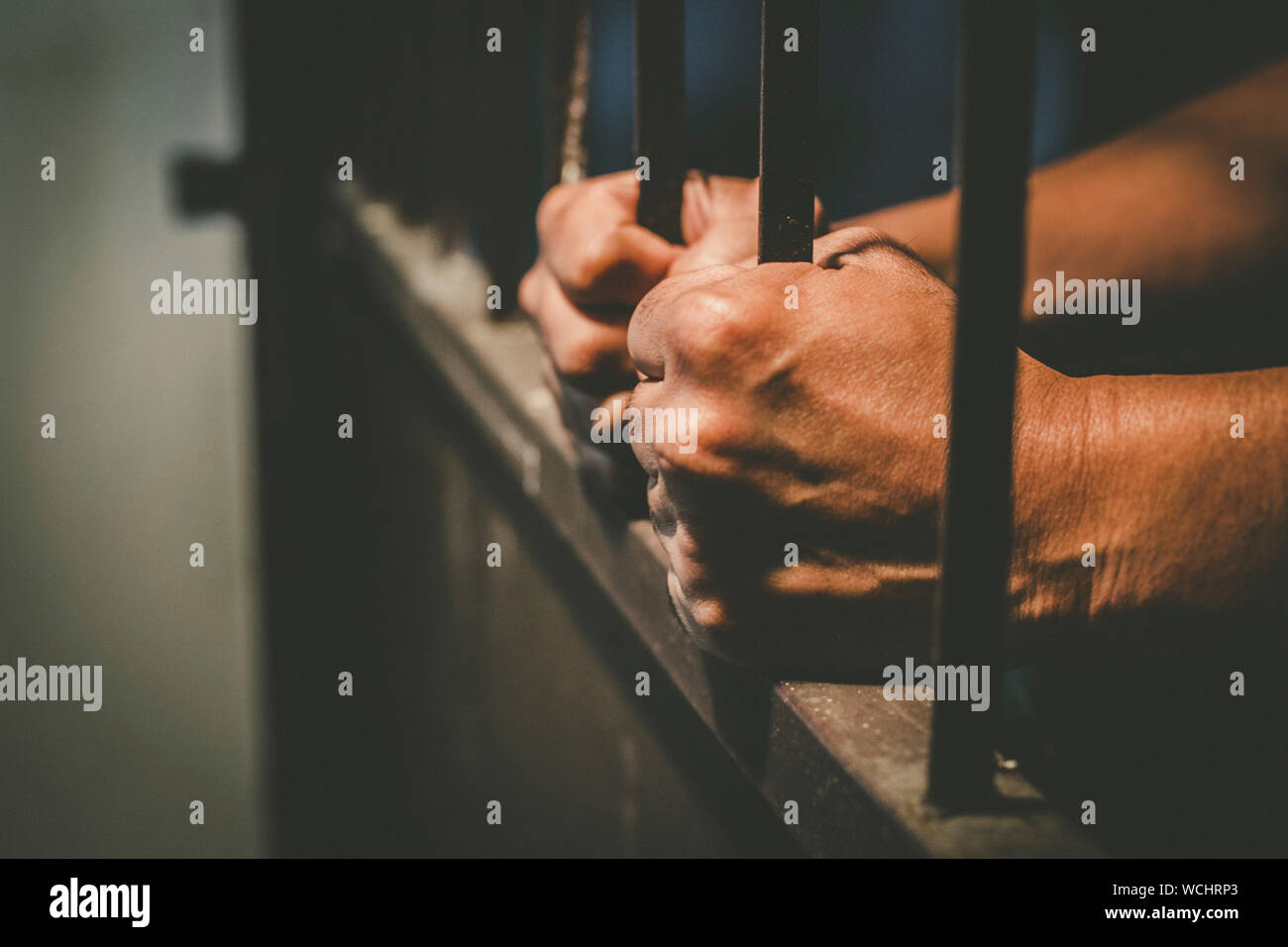 Cropped Hands Of Male Prisoner Holding Prison Bars Stock Photo Alamy