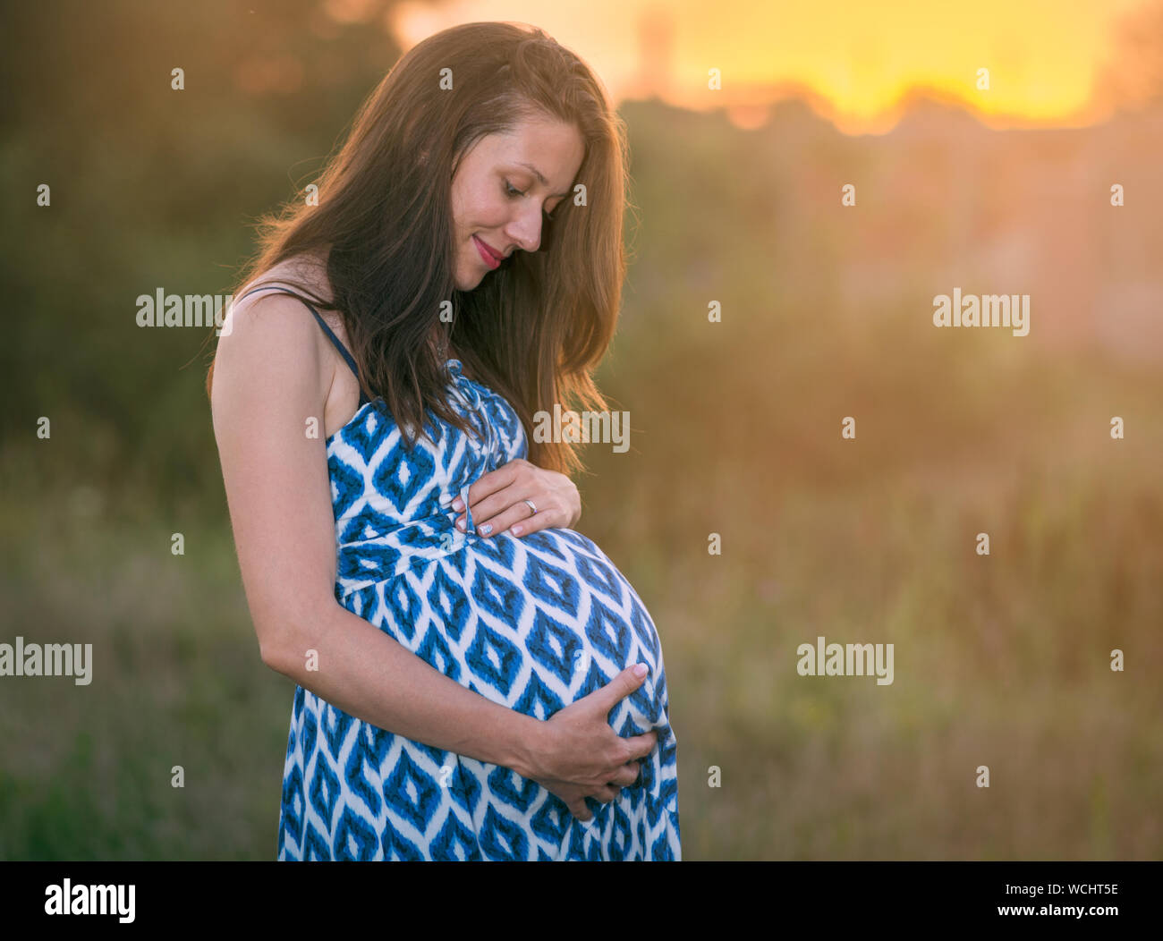 Serene Pregnant Woman Outdoors Stock Photo