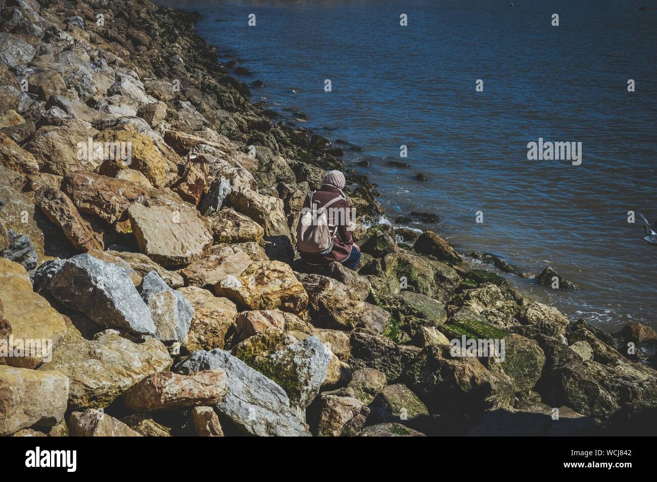Person sitting on rocks High Resolution Stock Photography and Images ...
