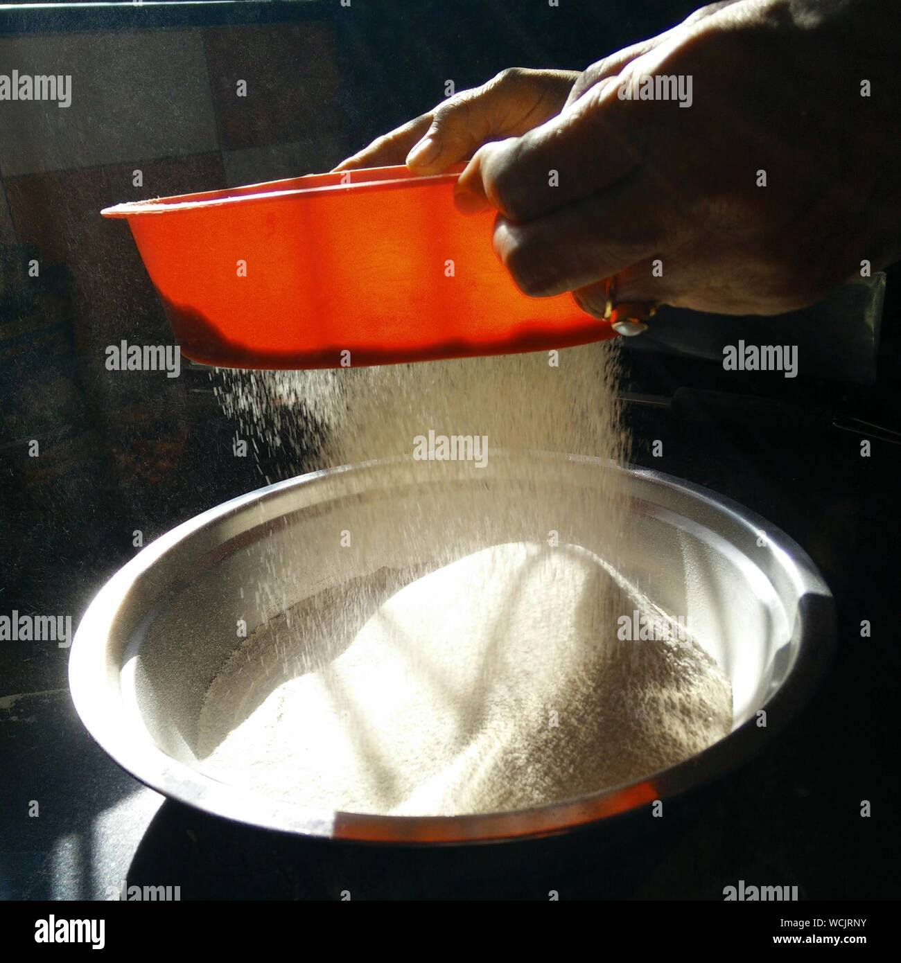 Cropped Hands Sieving Flour At Home Stock Photo Alamy